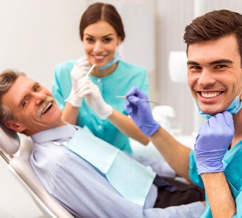 Patient and dental team smiling during dental checkup