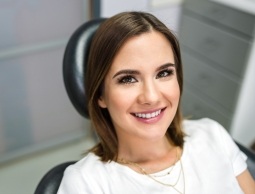 Smiling young woman sitting in dental chair