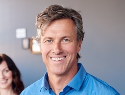 Smiling older man in blue button down shirt