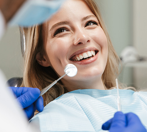 Woman smiling during gum disease treatment