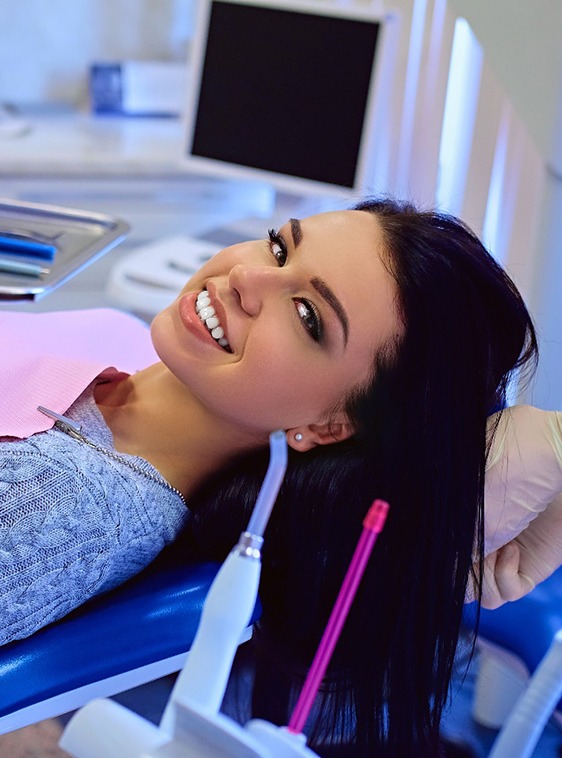Young woman smiling after a full mouth reconstruction in Houston, TX