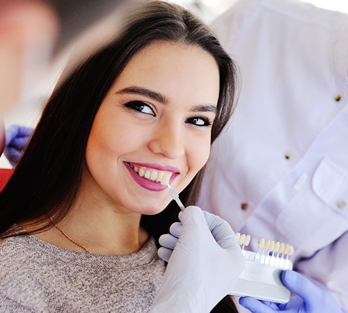 Woman smiling at dentist during veneer consultation