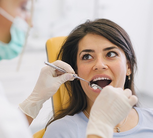 Woman receiving wisdom tooth extraction treatment