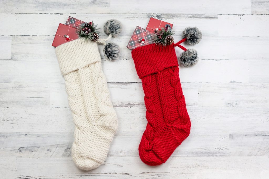 Red and white stockings with wrapped gifts inside