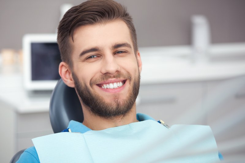 person smiling after receiving CEREC dental crown